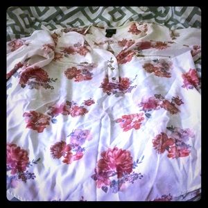 A white shirt with roses on it